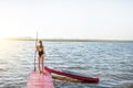 Woman with paddleboard on the pier outdoors Royalty Free Stock Photo