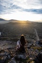 Beautiful woman standing on a cliff during sunset at Cap de Creus, Spain