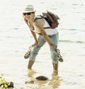 Beautiful woman is standing in the lake and holds her shoes Royalty Free Stock Photo