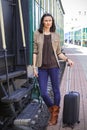 Beautiful woman standing with luggage near the vintage railcar Royalty Free Stock Photo