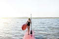 Woman with paddleboard on the pier outdoors Royalty Free Stock Photo