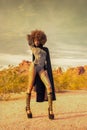 Beautiful woman standing proudly in wild desert location Royalty Free Stock Photo