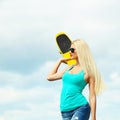 Portrait of a beautiful woman with a skateboard in her hands on the street Royalty Free Stock Photo