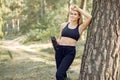 Beautiful woman standing in a summer park with water