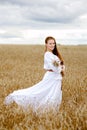 Beautiful woman standing in wheat field Royalty Free Stock Photo