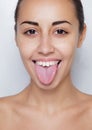 Beautiful woman sticking out her tongue and showing young piercing Royalty Free Stock Photo