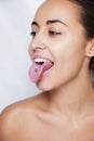 Beautiful woman sticking out her tongue and showing young piercing Royalty Free Stock Photo