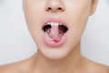 Beautiful woman sticking out her tongue and showing young piercing Royalty Free Stock Photo