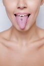 Beautiful woman sticking out her tongue and showing young piercing Royalty Free Stock Photo