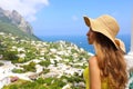 Beautiful woman with straw hat looking at Capri sight from terrace, Capri Island, Italy Royalty Free Stock Photo