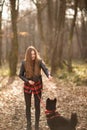 Beautiful woman stroking her dog outdoors. Pretty girl playing and having fun with her pet by name Brovko Vivchar