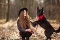 Beautiful woman stroking her dog outdoors. Pretty girl playing and having fun with her pet by name Brovko Vivchar