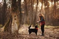 Beautiful woman stroking her dog outdoors. Pretty girl playing and having fun with her pet by name Brovko Vivchar