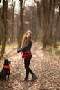 Beautiful woman stroking her dog outdoors. Pretty girl playing and having fun with her pet by name Brovko Vivchar