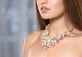 Beautiful woman with stylish jewelry against blurred lights. Space for text Royalty Free Stock Photo