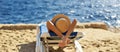 Beautiful woman sunbathing on a beach at tropical travel resort, enjoying summer holidays. Girl lying on sun lounger near the sea Royalty Free Stock Photo