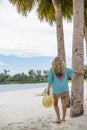 Beautiful woman in sundress walking on a tropical beach Royalty Free Stock Photo