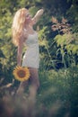 Beautiful woman between sunflower Royalty Free Stock Photo