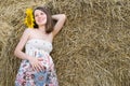 Beautiful Woman with Sunflowers near Haystack - Beauty and Fashion Royalty Free Stock Photo