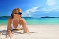 Beautiful woman in sunglasses sunbathing on the white sandy beach on the background of the islands Royalty Free Stock Photo