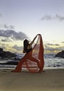 Beautiful woman at sunrise on beach