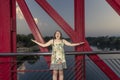 Beautiful woman surprised on a red bridge over Ebro, Spain