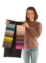 Beautiful woman in sweater holding fabric swatches Royalty Free Stock Photo
