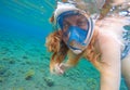 Beautiful woman swimming underwater. Red hair girl snorkeling in blue mask Royalty Free Stock Photo