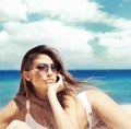 A beautiful woman in a swimsuit relaxing on the beach Royalty Free Stock Photo