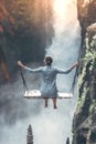 Beautiful woman swings near waterfall in the jungle of Bali island, Indonesia. Royalty Free Stock Photo