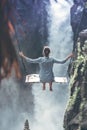 Beautiful woman swings near waterfall in the jungle of Bali island, Indonesia. Royalty Free Stock Photo