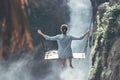 Beautiful woman swings near waterfall in the jungle of Bali island, Indonesia. Royalty Free Stock Photo