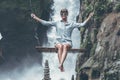 Beautiful woman swings near waterfall in the jungle of Bali island, Indonesia. Royalty Free Stock Photo