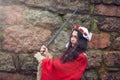 Beautiful woman swung the sword near the stone wall