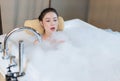 Woman takes a bath and blowing soap bubbles in bathtub Royalty Free Stock Photo