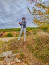 Beautiful woman takes a photo on Extensive opencast mines near Beroun. Czech.