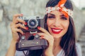 Beautiful woman taking photo with old fashioned film camera Royalty Free Stock Photo