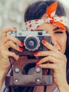 Beautiful woman taking photo with old fashioned film camera Royalty Free Stock Photo