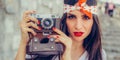 Beautiful woman taking photo with old fashioned film camera Royalty Free Stock Photo