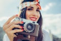 Beautiful woman taking photo with old fashioned film camera Royalty Free Stock Photo