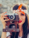 Beautiful woman taking photo with old fashioned film camera Royalty Free Stock Photo