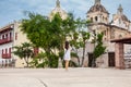 Beautiful woman taking pictures with her cellphone at the walls surrounding the colonial city of Cartagena de Indias