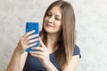 Beautiful woman taking selfie at home. Young cute girl talking via video link on a mobile phone with friends or relatives. Happy Royalty Free Stock Photo