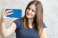 Beautiful woman taking selfie at home. Young cute girl talking via video link on a mobile phone with friends or relatives. Happy Royalty Free Stock Photo