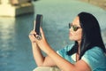 Beautiful woman taking a selfie at seaside cafe Royalty Free Stock Photo