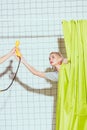 beautiful woman taking yellow retro telephone handset in shower