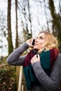 Beautiful woman talking on mobile phone in forest Royalty Free Stock Photo