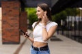Beautiful woman talking phone on air pods on the street Royalty Free Stock Photo