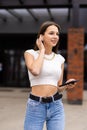 Beautiful woman talking phone on air pods on the street Royalty Free Stock Photo