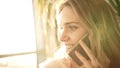 Beautiful woman talking phone. Portrait of talking woman smile in sun light Royalty Free Stock Photo